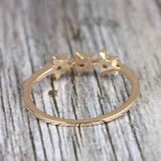 ❂ This ring made with natural diamonds in 14k yellow gold, ❂ Pave Diamond Three Star Ring Solid Gold Jewelry. ❂ Diamond Ring, Star Ring, Gold Ring, Everyday Jewelry ❂ Special customize for Mother's day, Anniversary, Birthday Gift, Valentine, Christmas. ❂ Item Details: Gross Weight: 2.05 Grams 14k Yellow Gold Weight: 2.00 Grams Diamond Weight: 0.25 Carats Item Size: US 7 Item SKU: ZR-2701 Gemstone color may vary due to natural and availability. This is a made to order design. Please allow 7-10 da Gold Star-shaped Diamond Ring For Formal Occasions, Dainty Star-shaped Yellow Gold Rings, Fine Jewelry Star-shaped Diamond Ring For Gifts, Tiny Star-shaped 14k Gold Jewelry, 14k Gold Star-shaped Ring For Gift, Ear Wrap Earrings, Ring Everyday, Gemstone Diamond Ring, Pave Diamond Band