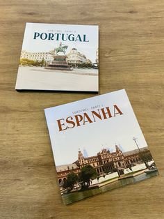 two books sitting on top of a wooden table next to each other with the title portugal and espanha