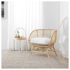 a rattan chair sits in front of a window