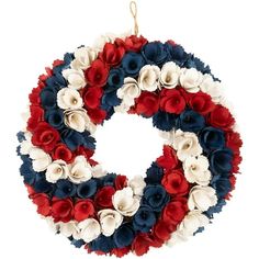 a wreath with red, white and blue flowers hanging on a wall ornament