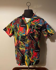 Vintage Hawaiian Shirt  - 100% cotton  - All over print design - Volcano graphic  - Abstract style art  - 70s/80s vintage  Size: L  Great vintage condition  No rips or holes  No stains Hawaiian Collared Tops With Graphic Print, Hawaiian Collared Top With Graphic Print, Patterned Graphic Print Hawaiian Cotton Shirt, Multicolor Cotton Hawaiian Shirt With All Over Print, Patterned Cotton Hawaiian Shirt With Graphic Print, Hawaiian Graphic Print Top With Camp Collar, Hawaiian Top With Graphic Print And Camp Collar, Hawaiian Camp Collar Graphic Print Tops, Hawaiian Camp Collar Top With Graphic Print