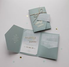 the wedding stationery is laid out with confetti and twine on it