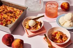 peach cobbler with ice cream and peaches in bowls on a white tablecloth