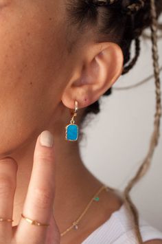 "Shiny turquoise earrings in huggie hoop earrings feature secure and smooth closure, all while adding a dainty pop of color with the turquoise gemstone. Dainty and simple gold hoop earrings, perfect for stacking and layering with your favorite accessories. Add a touch of boho vibe to your Valentines Day Gift selection with our beautiful gold turquoise earrings effortlessly. Inspired by royal blue turquoise gemstone and the simplicity of gold hoop earrings, we've created elegant Bella open hoop e Turquoise Hoop Earrings Gold, Simple Gold Hoop Earrings, Earrings Stacking, Gemstone Hoop Earrings, Turquoise Hoop Earrings, Turquoise Hoops, Gift Sister, Turquoise Howlite, Silver Gifts