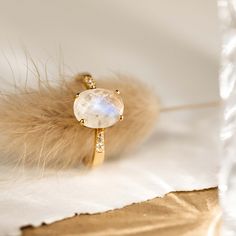 The Moonstone Ring (Serena) features an oval rainbow moonstone set on a gold tapered band. This elegant statement ring is flanked by cubic zirconia stones that shine brilliantly like diamonds. We love this ring because of its intriguing blue and white tones!


The rainbow moonstone measures 10mm x 8mm.
 Size: 4, 5, 6, 7, 8, 9, 10 Moonstone Gold Ring, Gold Moonstone Ring, Silver Rings For Women, Gold Vermeil Jewelry, Big Rings, Moonstone Jewelry, Cheap Jewelry, Traditional Jewelry, Moonstone Ring