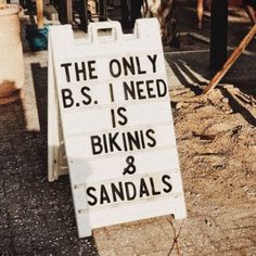 the only b s i need is bikinis and sandals sign in front of a restaurant