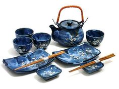 a blue tea set with chopsticks and bowls