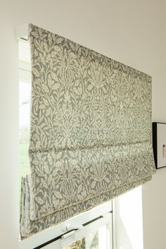 the roman blind is hanging on the wall