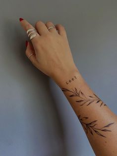 a woman's hand with a tattoo on her left wrist and the word cool written in cursive writing