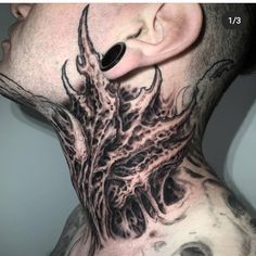 a man with tattoos on his neck and behind the ear is an intricate piece of art