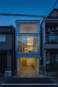 an apartment building with glass walls on the outside