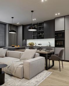 a living room filled with furniture next to a kitchen and dining room table in front of a window