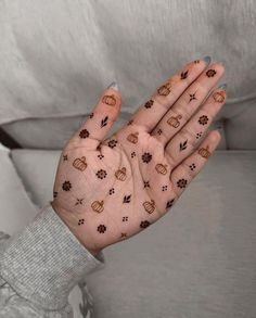 a woman's hand with dog paw prints on it, holding her hands out to the side