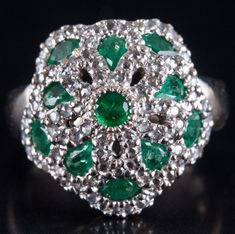 18k Yellow Gold Rhodium Plated Emerald Diamond Cocktail Style Ring 1.95ctw 9.5gMetal Information: 18k Yellow Gold Rhodium PlatedTotal Weight: 9.5gBand Width: 3.4mmSize: 6.5Additional Information: Ring Is Rhodium PlatedStone InformationMain StoneGem Type: EmeraldShape: Round (3.75mm)Color: GreenClarity/Quality: AA - BCarat Weight: .17ctNumber of Stones: 2Accent StonesGem Type: EmeraldShape: Round (3.25mm)Color: GreenClarity/Quality: AA - BCarat Weight: .13ctNumber of Stones: 1Accent StonesGem Typ Silver Emerald Ring With Brilliant Cut Cluster, Silver Emerald Ring With Brilliant Cut In Cluster Shape, Platinum Cluster Gemstone Jewelry, Silver Cluster Emerald Ring Fine Jewelry, Platinum Cluster Jewelry With Gemstone, Silver Platinum Emerald Ring With Multiple Stones, Silver Emerald Ring With Pave Setting For Wedding, Wedding Silver Emerald Ring With Pave Setting, Silver Cluster Emerald Gemstone Ring