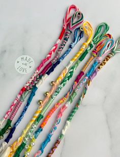 several different colored lollipop canes are lined up on a marble countertop