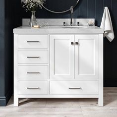 a white bathroom vanity with marble top and two mirrors on the wall next to it