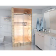 a bath room with a toilet and a shower stall next to a sink on a tiled floor