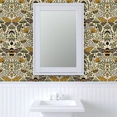 a white sink sitting under a bathroom mirror next to a wall mounted faucet