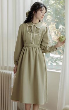 A polished statement piece with an Edwardian flair. Crafted from a comfortable fabric, it features a timeless peter pan collar with delicate lace trims, pleated details on the chest with faux button-up front, and long sleeves. Its tie waist gives way to a midi length skirt, perfectly balancing sophistication and elegance. Concealed back zipper. S: 34.5" chest, 30" waist, 43" lengthM: 36" chest, 31.5" waist, 43" lengthL: 37.5" chest, 33" waist, 43.5" lengthXL: 39" chest, 34.5" waist, 43.5" length Casual Long Sleeve Dress With Lace Collar, Fitted Long Sleeve Dress With Pintucks, Long Sleeve Formal Dress With Pintucks, Green Lace Trim Dress For Fall, Formal Long Sleeve Dress With Pintucks, Fall Workwear Dresses With Doll Collar, Doll Collar Dresses For Fall Workwear, Doll Collar Dresses For Work In Fall, Elegant Long Sleeve Olive Dress