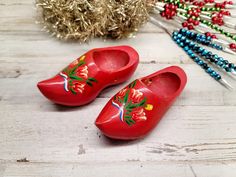 "What you see you will be getting. Adorable Dutch Clogs/ or Elf shoes for Christmas décor. They do have holes on the inside to insert a string to put them on a tree or hand in room decor. Measures: 4.5\" long/ 2\" wide. Hand painted  If you have any questions feel free to message me. Check out the phots and video provided. Salena" Red Clogs With Wooden Heel And Round Toe, Dutch Wooden Shoes Decor, Wooden Shoes Dutch, Wooden Clogs Dutch, Red Slip-on Clogs With Wooden Heel, Wooden Slip-on Clogs With Wooden Heel, Dutch Clogs, Shoe Ornaments, Elf Shoes