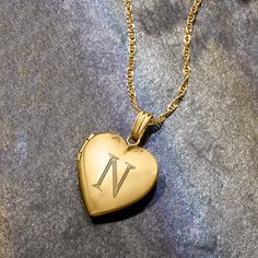 Ross-Simons - Single-Initial - 14kt Yellow Gold Heart Locket Necklace. 18". Make her day with our luxe symbol of love! Crafted in polished 14kt yellow gold, our heart locket necklace is a timeless choice for so many occasions. Fits a 5/16" x 3/8" photo inside. Suspends from a rope chain. FREE engraving of a single initial in your choice of block or script type. Springring clasp, 14kt yellow gold personalized heart locket necklace. 14k Yellow Gold Locket Necklace For Anniversary, Personalized Heart Medallion Necklace For Anniversary, Personalized Medallion Heart Necklace For Anniversary, Heirloom Yellow Gold Necklace With Hallmarks, Personalized Yellow Gold Locket Necklace With Initial Pendant, Personalized Heart Shaped Yellow Gold Jewelry, Yellow Gold Initials Jewelry Keepsake, Yellow Gold Initials Jewelry For Keepsake, Personalized Sterling Silver Yellow Gold Locket Necklace