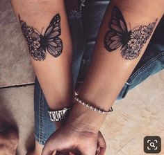 two people holding hands with butterfly tattoos on their arms