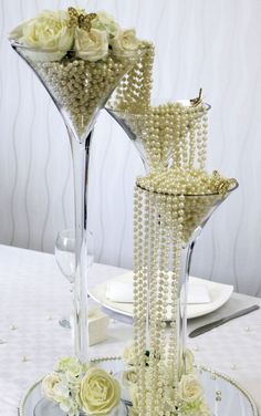 two tall vases filled with pearls and flowers