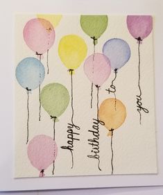 a birthday card with watercolor balloons on it