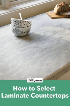 a counter top with a bowl on it next to some bread and a window sill