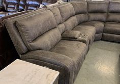 a sectional couch with recliners in the background