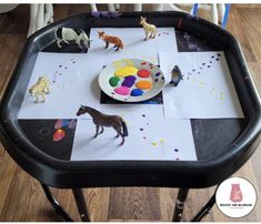 a black tray topped with paper and toys