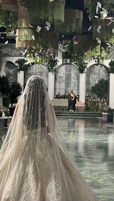 a woman in a wedding dress standing next to a man