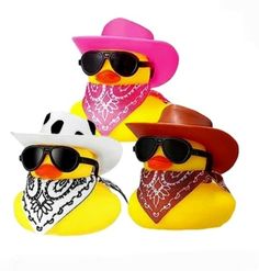 three rubber ducks with hats and sunglasses on their heads, one wearing a bandana