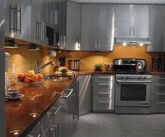 a modern kitchen with stainless steel appliances and granite counter tops is pictured in this image