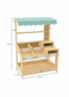 a wooden toy kitchen with drawers and an awning over the counter top for storage