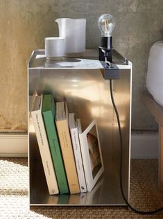 a book shelf with books and a lamp on top