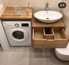 a washer and dryer sitting next to each other in a bathroom