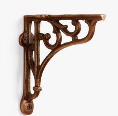 an ornate wooden shelf bracket on a white wall