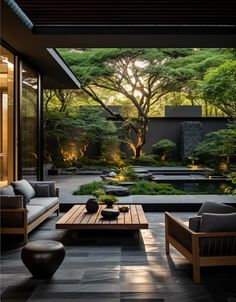 a living room filled with lots of furniture and plants in the middle of an outdoor area