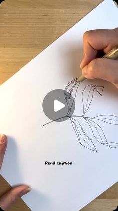 someone is drawing a flower on paper with a pencil and marker, while another person holds a pen in their left hand