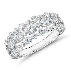 a white gold ring with round diamonds on the sides and two rows of smaller stones