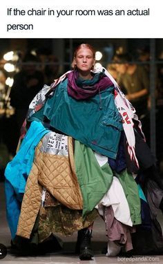 a woman is standing in front of a pile of clothes