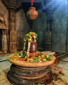 an elaborate fountain with flowers and greenery on it