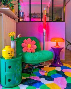 a brightly colored living room with flowers on the table and colorful furniture in front of it