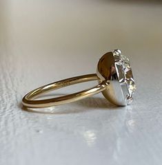 a diamond ring sitting on top of a table