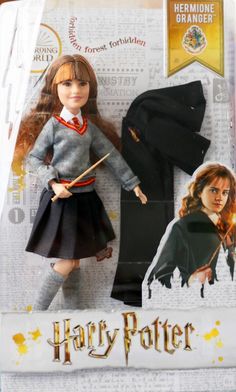 the doll is wearing a harry potter outfit and holding a wand in her hand,