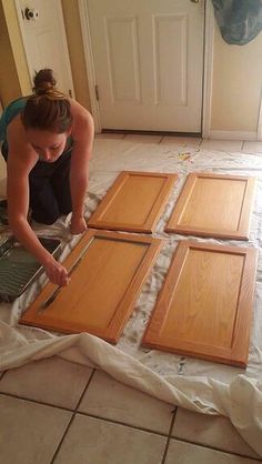 a woman laying on the floor with some wooden doors