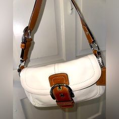 A Y2k Must Have!! Two Tone In White And Brown Leather In Excellent Condition!! Was Never Used! The Interior Is The Prettiest Purple And In Pristine Condition. There Are 2 Small Color Transfer Spots Barely Noticeable. This Bag Is Stunning! White Crossbody Shoulder Bag With Silver-tone Hardware, Classic White Shoulder Bag With Branded Hardware, White Shoulder Bag With Silver-tone Hardware, White Leather Shoulder Bag With Handles, White Rectangular Coach Shoulder Bag, Coach White Leather Shoulder Bag, White Leather Coach Shoulder Bag, White Crossbody Bag With Silver-tone Hardware, White Rectangular Shoulder Bag With Branded Hardware