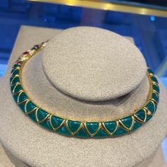 Excellent Condition Vintage Van Cleef & Arpels choker necklace.A true heirloom which will be wearable the moment it arrives. Excellent Condition, no damage to any of the gemstones. All joints are tight and secure. This vintage, handcrafted Van Cleef Arpels necklace is the epitome of sophisticated elegance. Crafted in 18K yellow gold, it features a stunning inlay of chrysoprase throughout, with pink tourmaline stones as the centerpiece, and is accented with brilliant diamonds, offering a timeless look that is sure to add a touch of luxury to any ensemble. Details: 18K Yellow Gold Weighs 145.97 grams 16" Long Hallmarked Van Cleef Arpels 18K B4589I1 Integrated hinged clasp Includes original Van Cleef Arpels Blue Pouch Green Chrysoprase Chalcedony Inlays Center Pink Tourmaline = Approximately Luxury Green Cabochon Necklace, Formal Gemstone Choker Necklace, Green Gemstone Jewelry For Ceremonial Occasions, Green Gemstone Jewelry For Ceremonial Use, Ceremonial Hallmarked Green Jewelry, Green Choker Jewelry For Formal Occasions, Formal Temple Jewelry Choker Necklace, Formal Temple Jewelry Style Choker Necklace, Green Formal Choker Jewelry