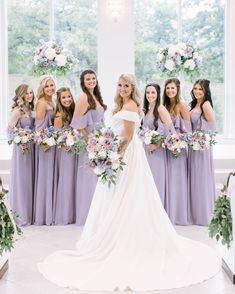 a bride and her bridal party posing for a photo